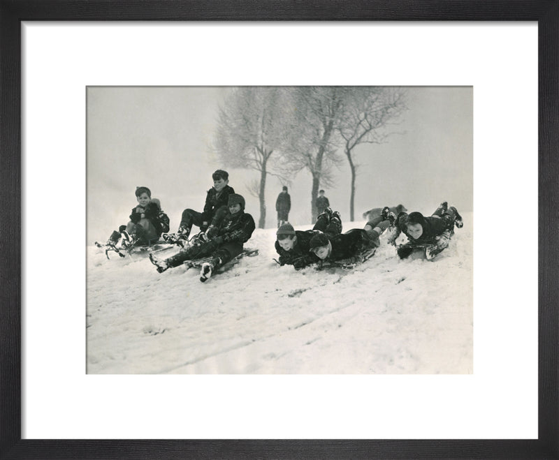 Children sledging, 1955 by Mirrorpix. Framed art print.