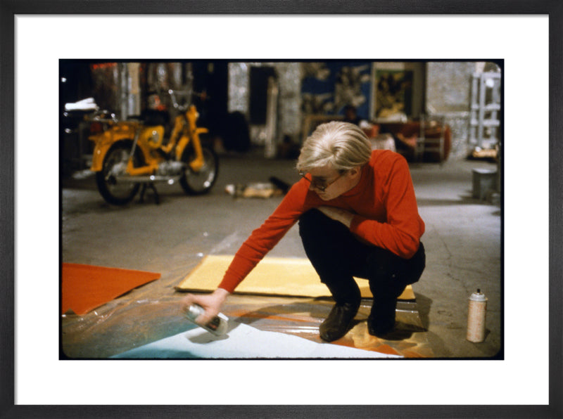 Andy with Spray Paint and Moped, The Factory, NYC, circa 1965 by Nat Finkelstein. Framed art print.